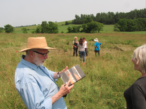 Murray Schafer standing in a field in summer