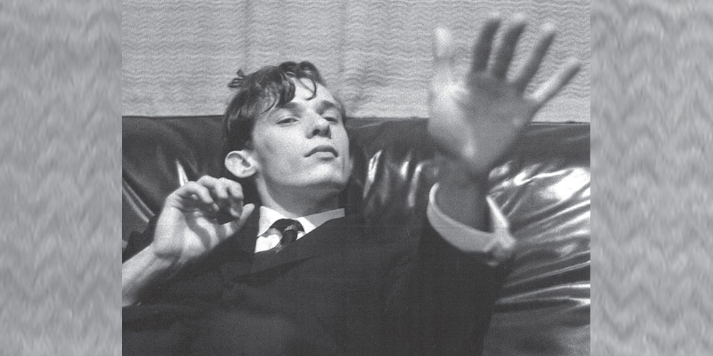 A young Glenn Gould holding his left hand up